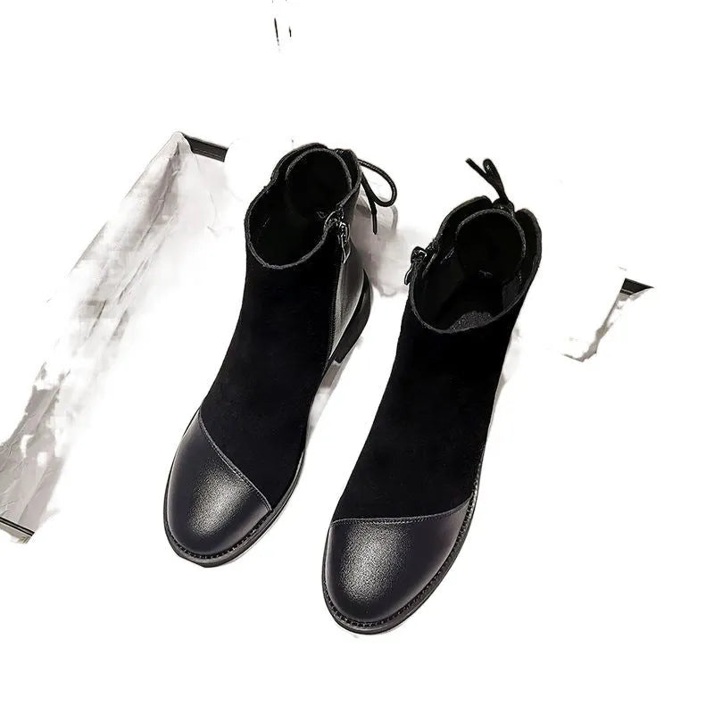 Women's black knee-length Martin boots with side zipper, non-slip rubber sole, and bow detail on microfiber upper