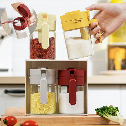 Small glass seasoning jars with lids and spoons in various colors for kitchen organization