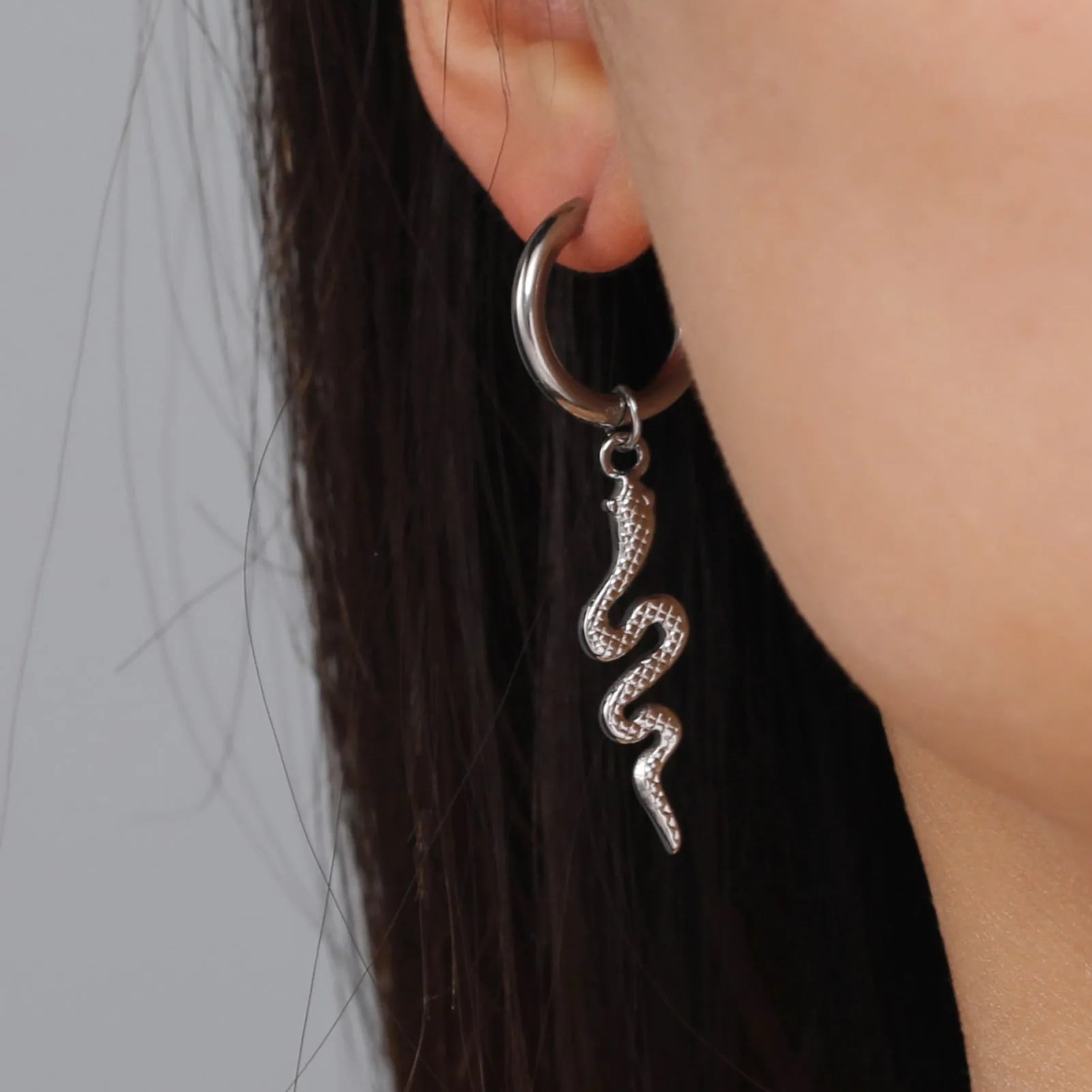 Gold coloured snake-shaped vintage clip-on earrings made from stainless steel.