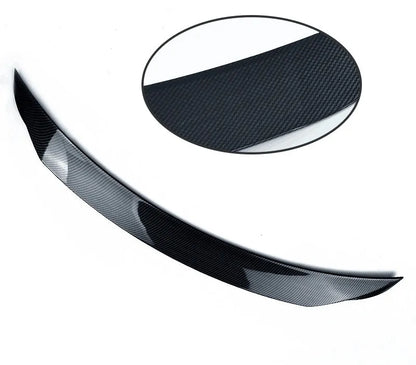 Mazda 3 Axela Exela tail trim in bright black with large fixed wind surround, showing precise fitment on vehicle rear