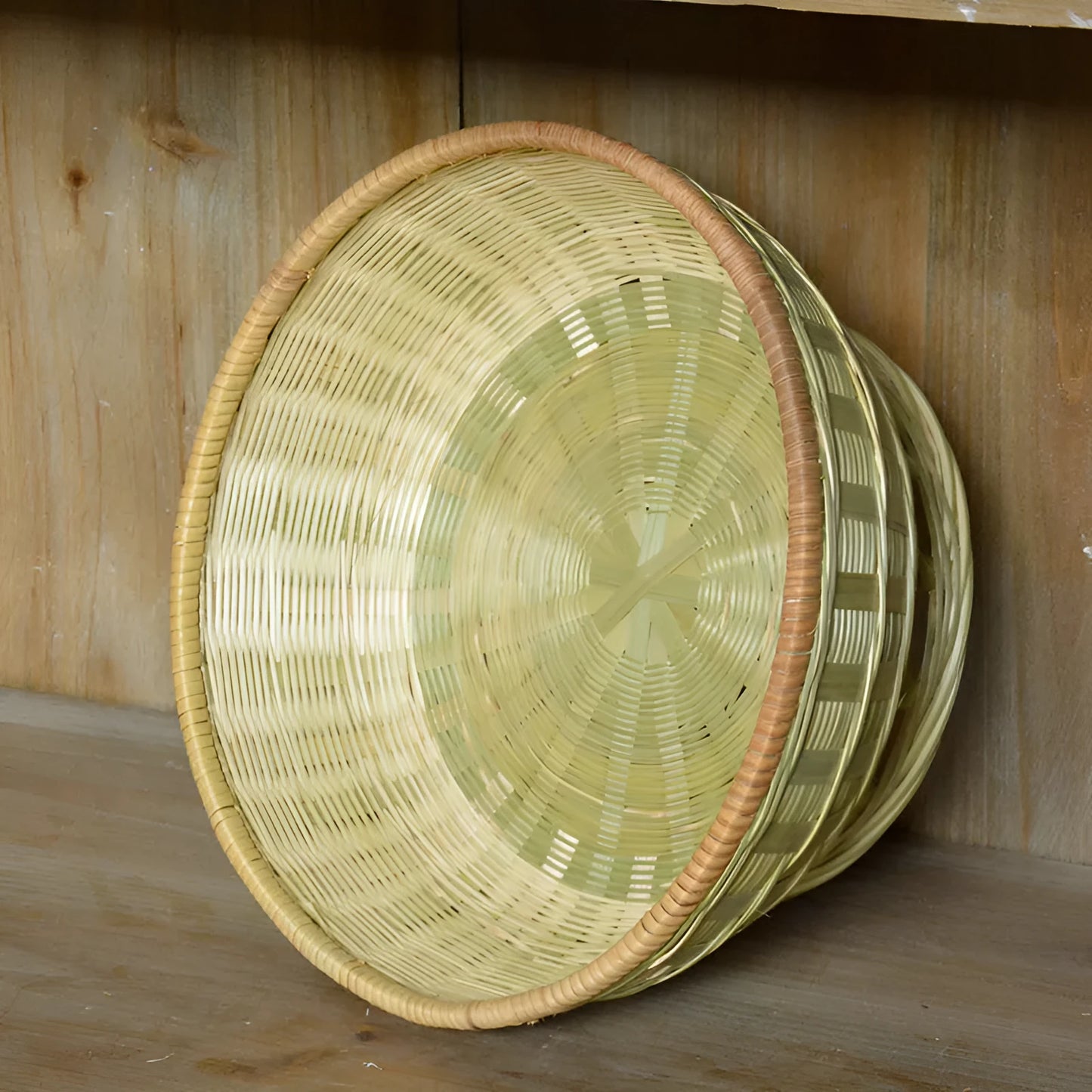Handmade bamboo storage basket with woven design in 26x8cm, 25x9cm, and 24x12cm sizes on a wooden table