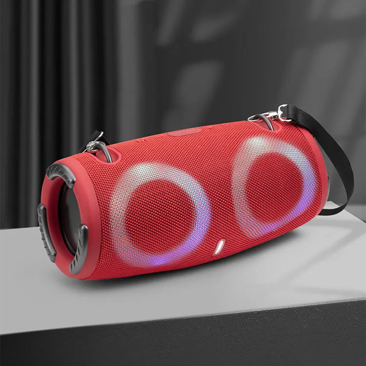 War Drum Bluetooth speaker in blue with RGB coloured lights, showing waterproof design and included strap for portable use