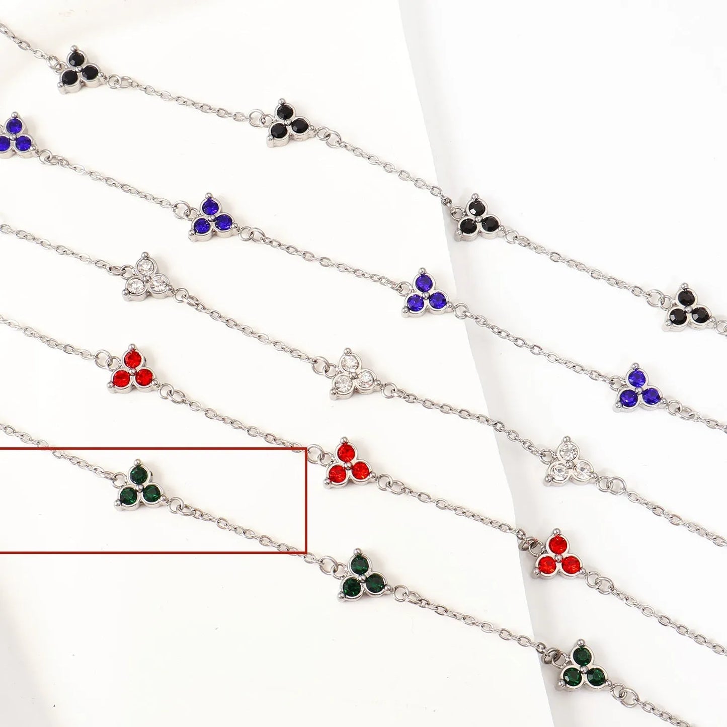 Women's stainless steel bracelet with three triangle-shaped charms in different coloured stone settings