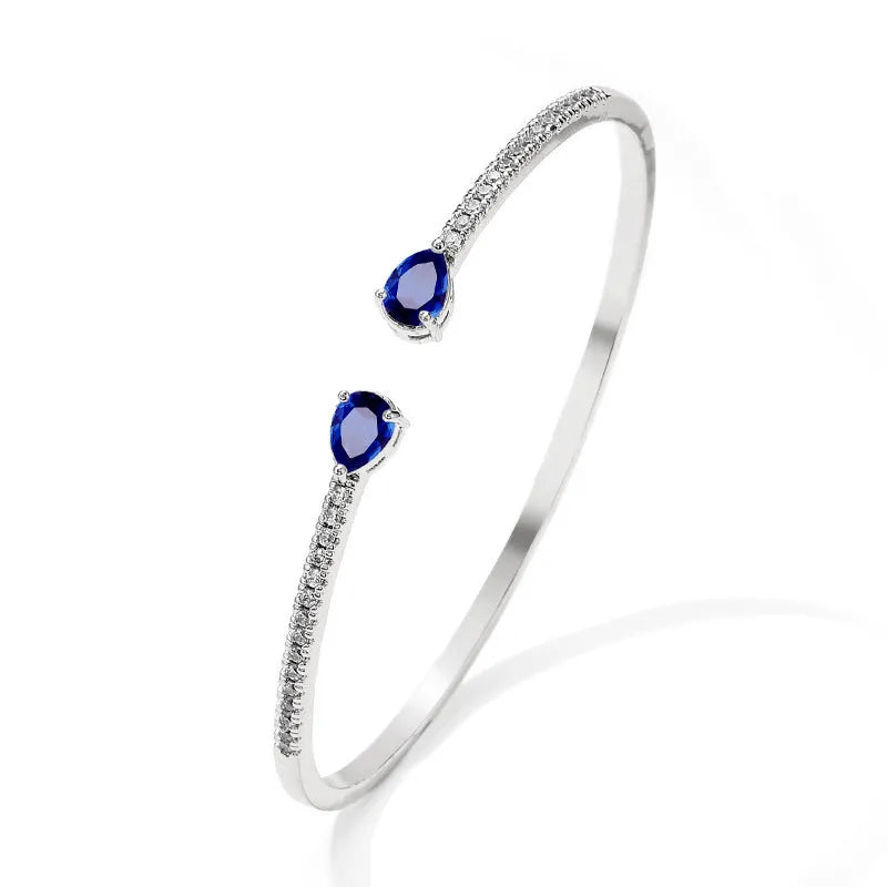 Close-up of a multi-zircon inlay fashion bracelet in copper, shown in blue and white colour options.