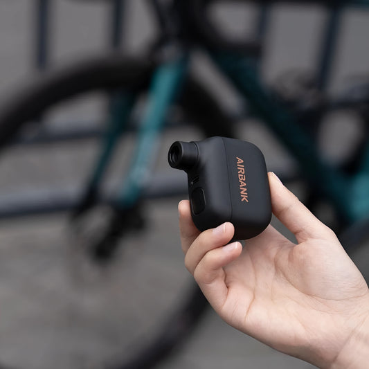 Black AS100 portable electric bike tyre inflator with USB cable and waterproof bag