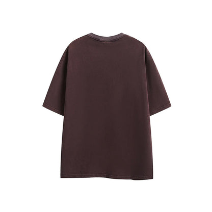 Purple washed cotton T-shirt with embroidery, loose fit, shown on a hanger.