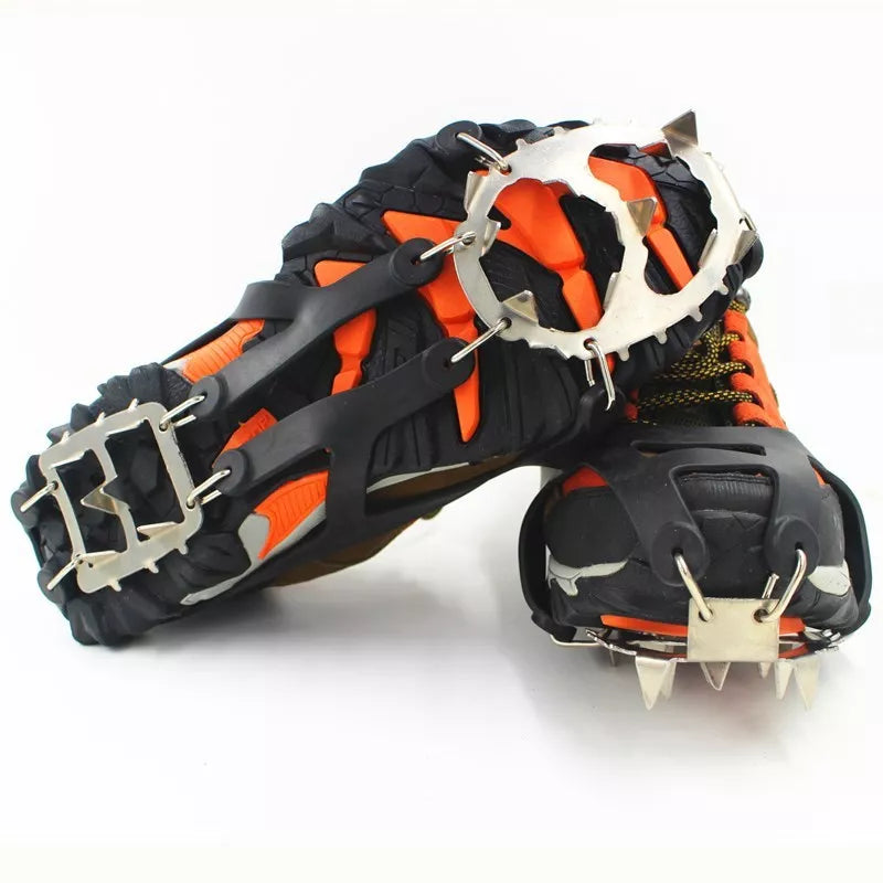 Reinforced large-tooth non-slip shoes in black and orange for superior traction on slippery surfaces