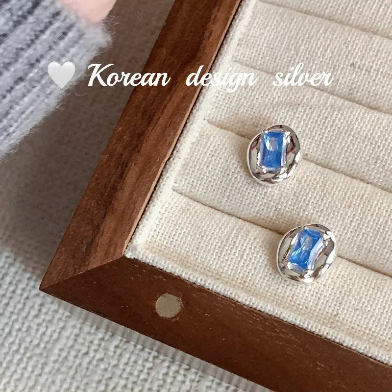 Women's S925 sterling silver earrings with oval blue diamond heart-wrapped design