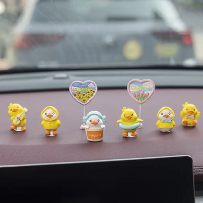 Set of six small yellow PVC ducklings and a white Hello sign for car dashboard decoration.