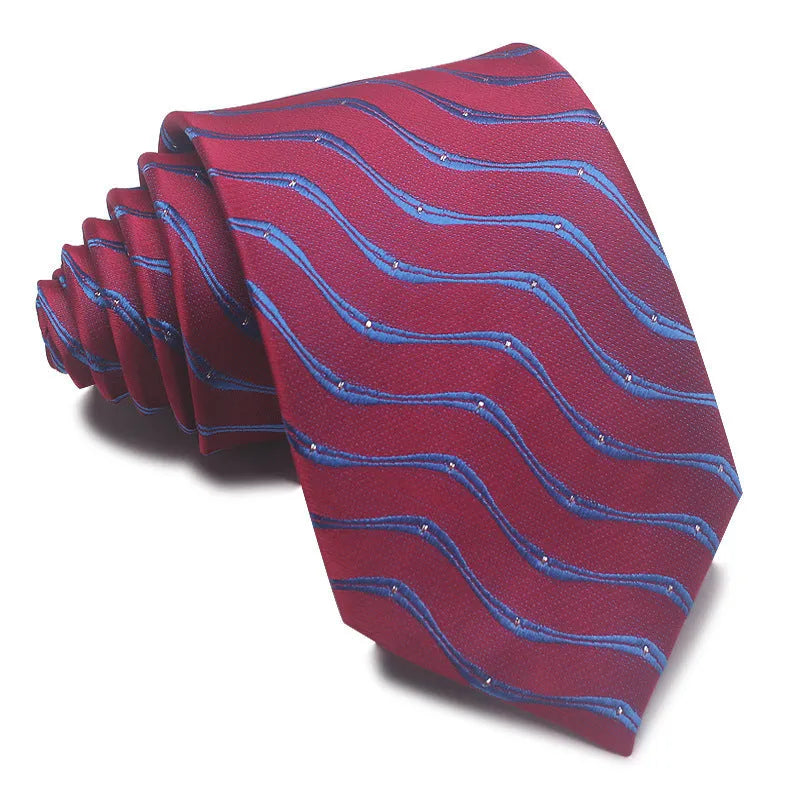 Close-up of a red and black striped jacquard weave tie with an arrow tip, showing texture.