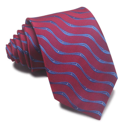 Close-up of a red and black striped jacquard weave tie with an arrow tip, showing texture.
