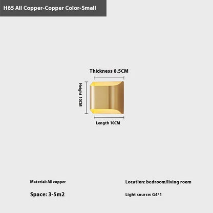 Minimalist copper wall lamp in black gold finish mounted beside bed