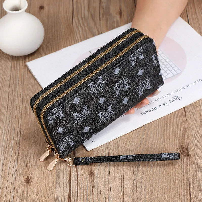 Long black retro-style PU leather wallet clutch with a printed pattern, showing a mobile phone pocket and a zippered coin purse.