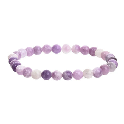 Purple geometric stone bead bracelet on an elastic band, showing manual craftsmanship.