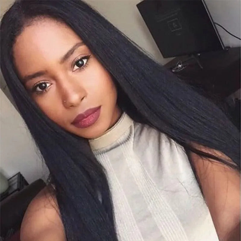 Long black straight synthetic wig on a stand, showing centre parting and full fringe