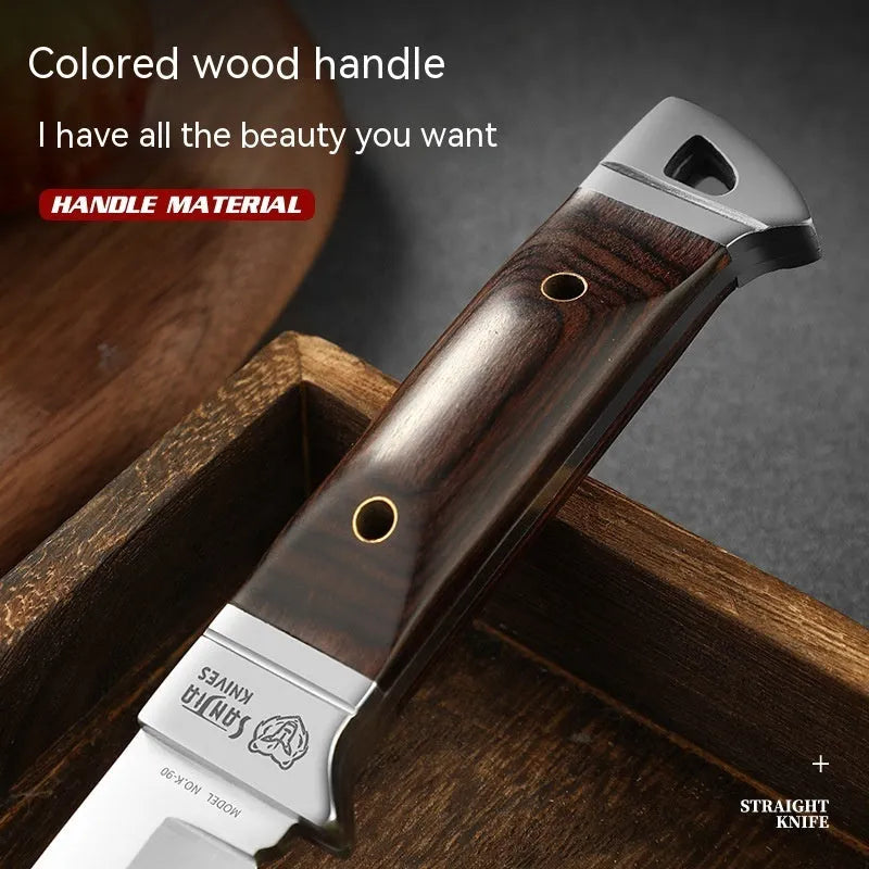 Camping fruit knife with stainless steel blade and brown leather sheath on a wooden surface