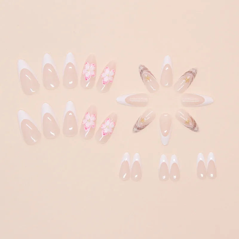 Set of floral French tip false nails with grey rock pattern accents on a simple pink base.