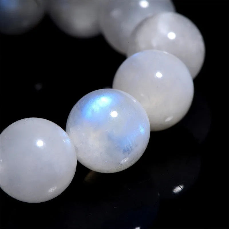 Natural blue moonlight round bead bracelet in white with polished moonstone beads showing blue sheen effect
