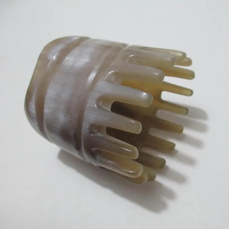 Black half-moon shaped buffalo horn comb with wide teeth for scalp massage and detangling hair.