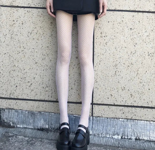 Women's black and white mesh stockings showing large, medium, and small hole patterns.