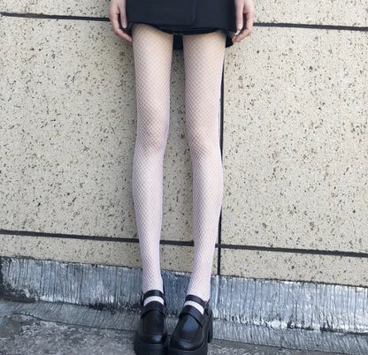 Women's black and white mesh stockings showing large, medium, and small hole patterns.