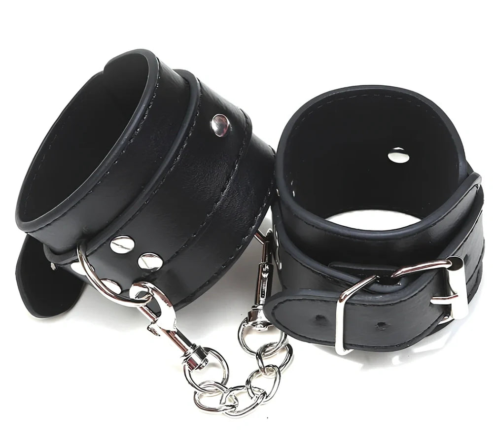 Black PU leather BDSM handcuffs showing adjustable buckle and 20cm connecting chain