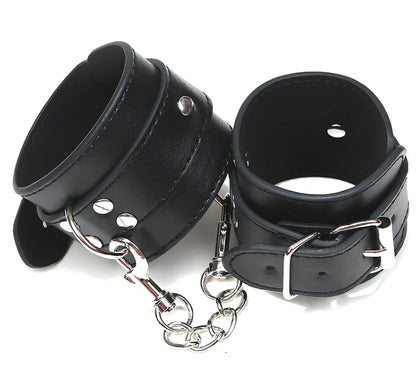 Black PU leather BDSM handcuffs showing adjustable buckle and 20cm connecting chain