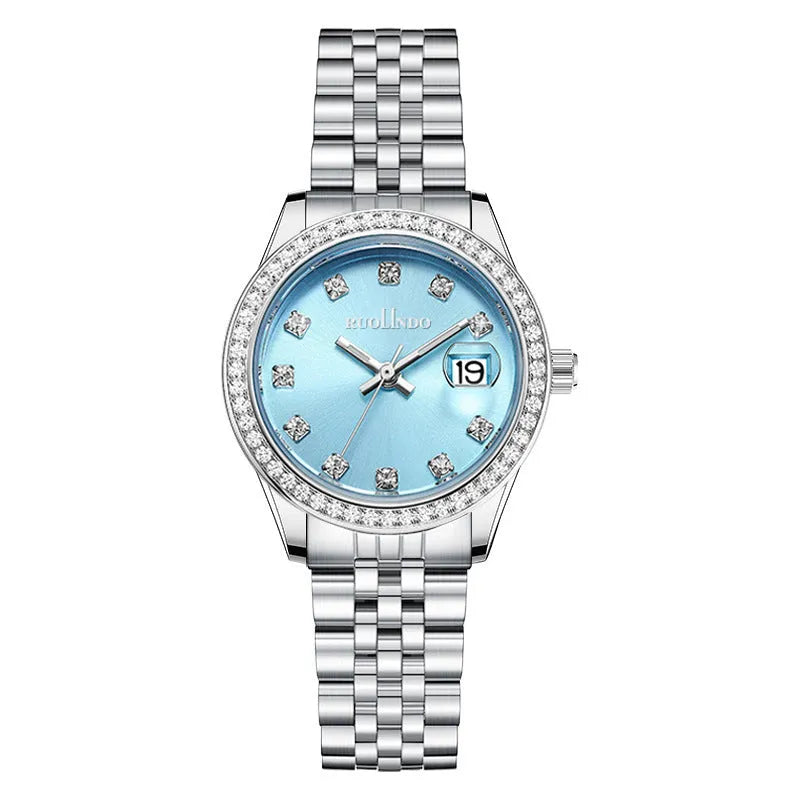 Women's silver alloy calendar watch with quartz movement and stainless steel buckle on wrist.