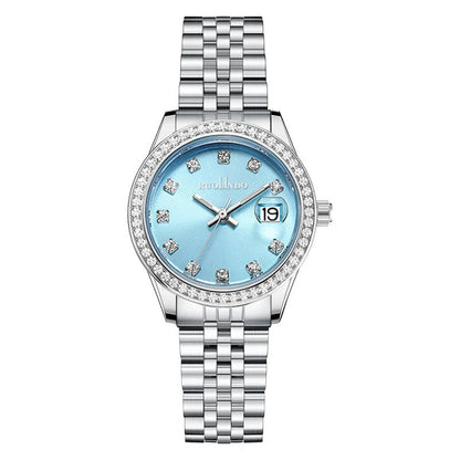 Women's silver alloy calendar watch with quartz movement and stainless steel buckle on wrist.