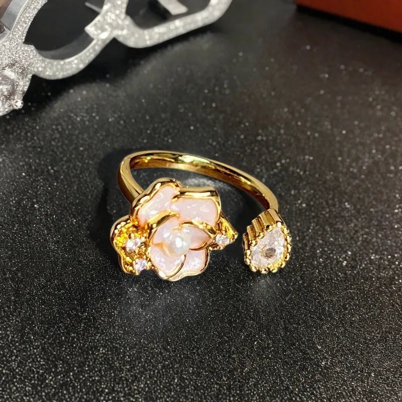 Adjustable copper gourd ring with zircon stones showing flower and bow design elements