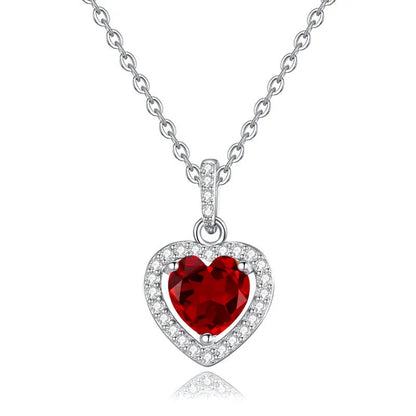 Sterling silver heart pendant necklace with a coloured gemstone on an adjustable chain.