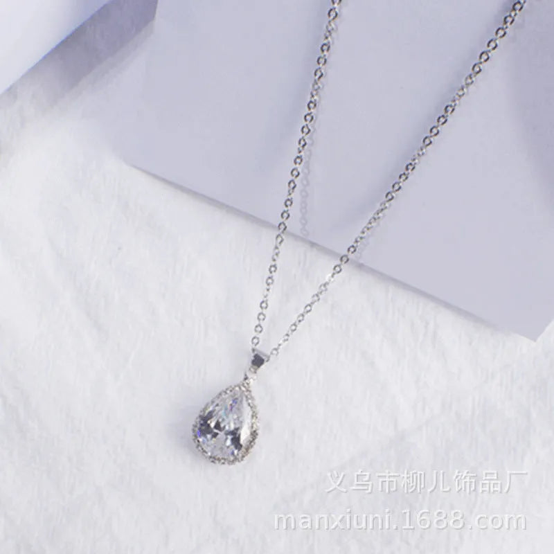 Rose gold geometric water drop pendant necklace on a model, showing adjustable chain and sparkling stone inlay.