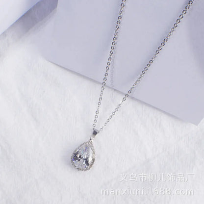 Rose gold geometric water drop pendant necklace on a model, showing adjustable chain and sparkling stone inlay.