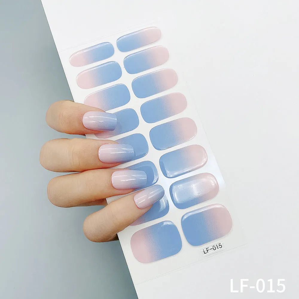 Sheet of 16 small design nail art stickers including cross, rose, tulip and marble patterns.