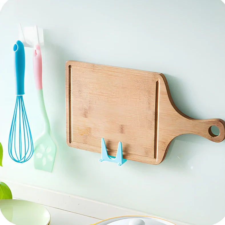 Blue plastic kitchen organiser mounted inside cabinet door holding spatula and spoon
