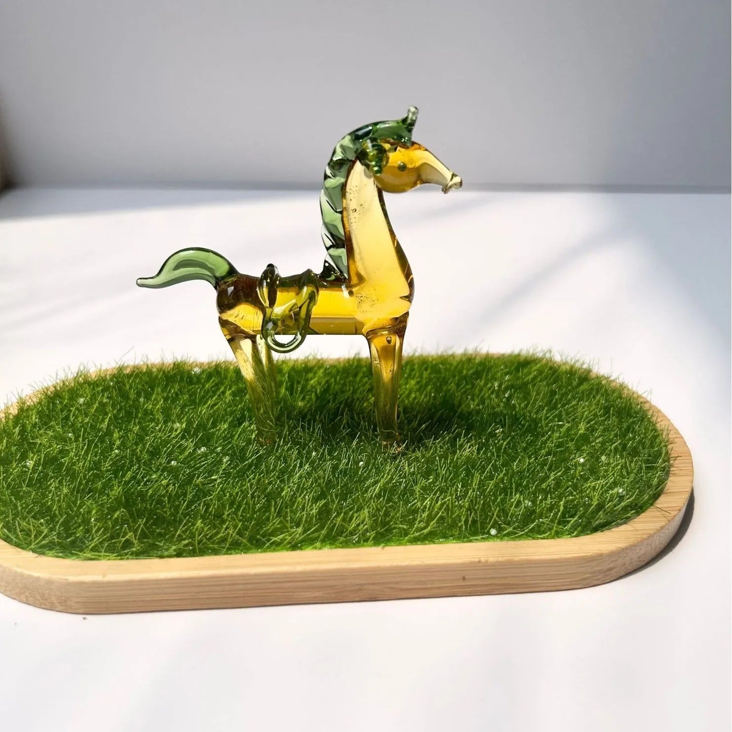 Brown glazed horse decoration on wooden desk with modern minimalist design and glossy finish