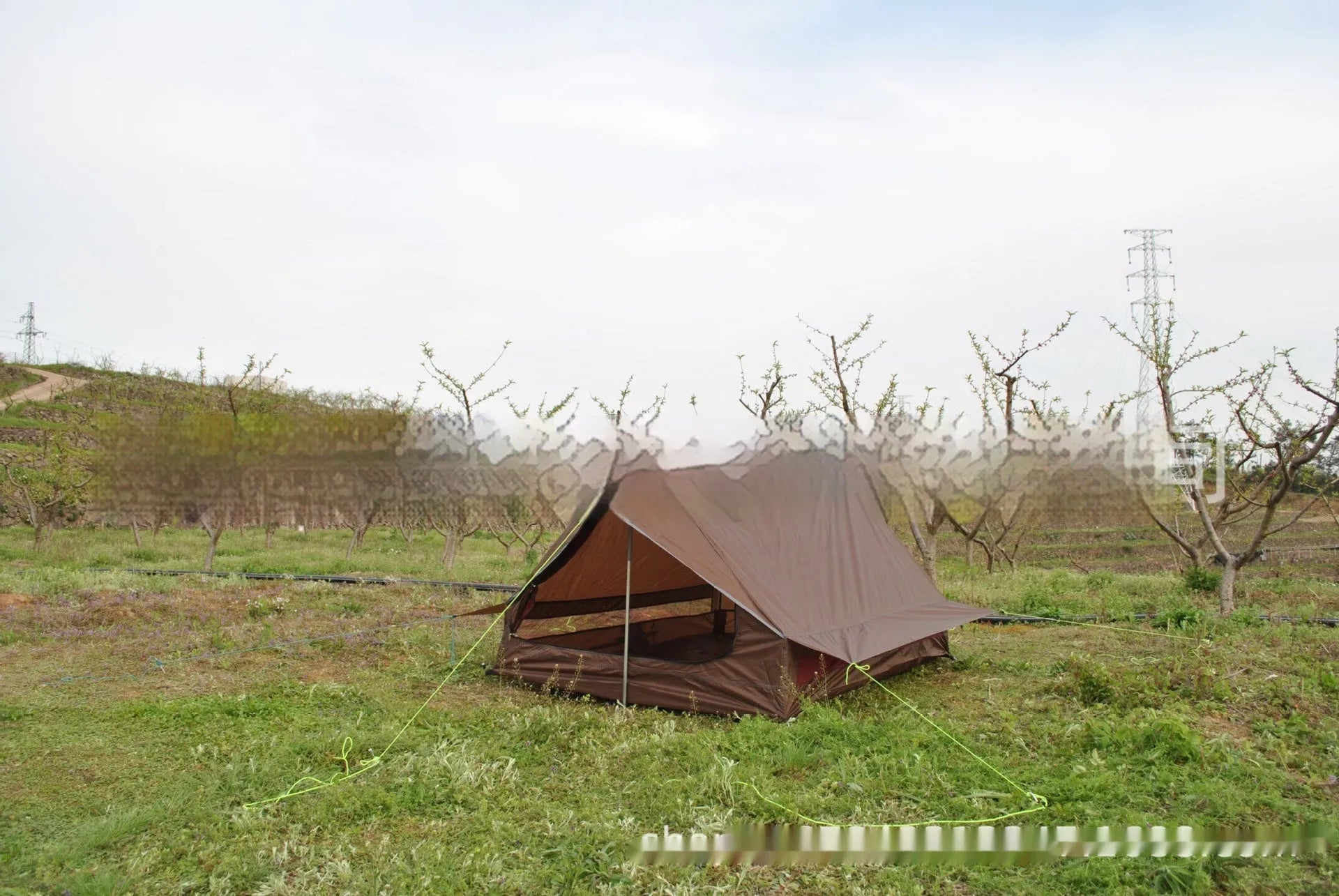 Brown and white portable A-line camping tent set up with hiking poles, showing its spacious interior for 2-3 people.