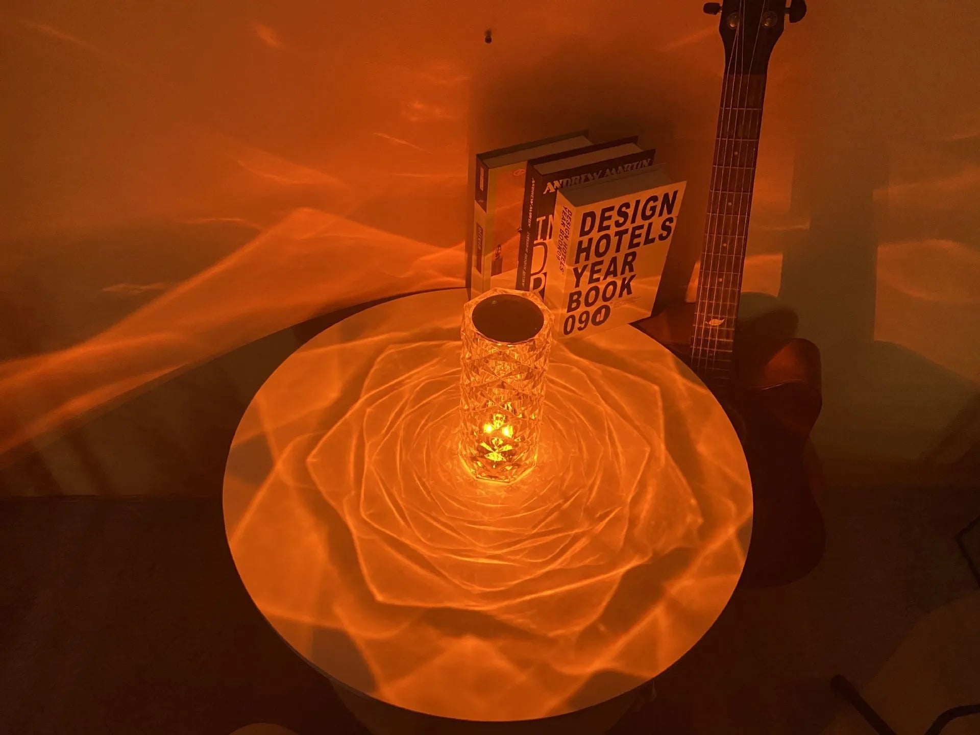 Modern minimalist acrylic crystal rose LED table lamp with touch switch on a wooden table.