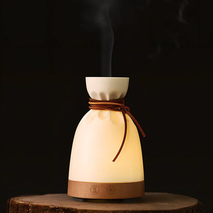 Warm yellow aromatherapy humidifier with beech wood elements and 140ml water tank capacity