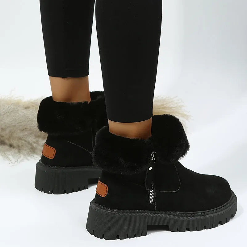 Women's black high top snow boots with a faux suede upper and side zipper on a white background.