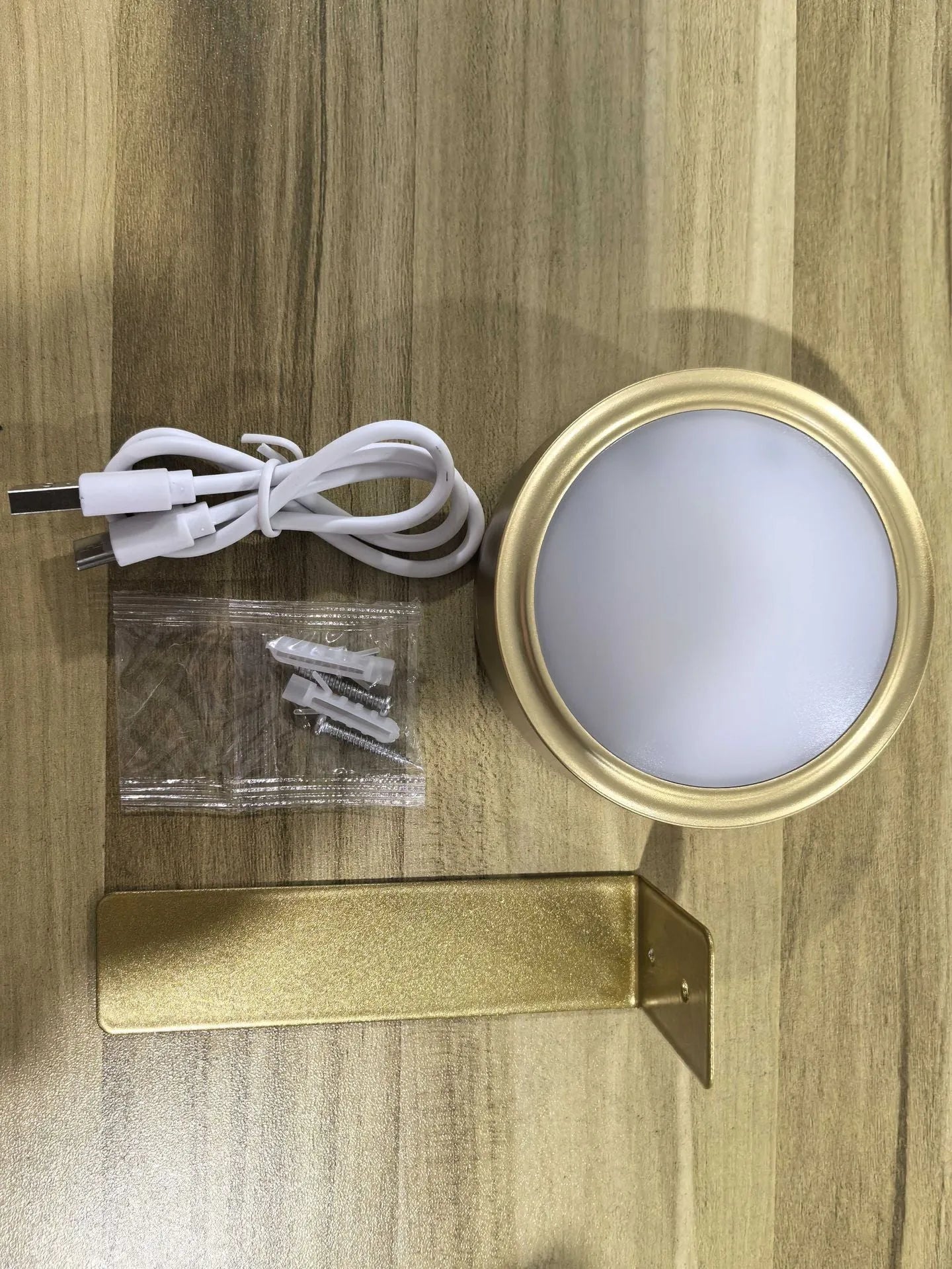 Black magnetic LED painting lamp with remote control on a white wall.