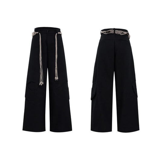Men's dark blue straight-leg cotton jeans with 3D cutting, belt stitching, and decorative tassel on a hanger