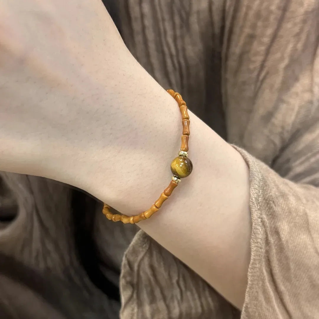 Natural yellow Tiger's Eye bracelet with Hetian jade elements and gold gourd charm on wrist
