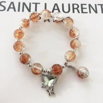 Chinese style glass bead bracelet with bamboo joint design on wrist.