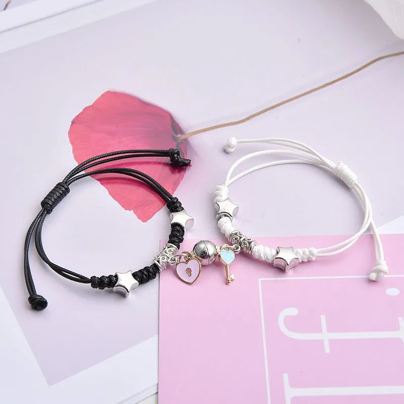 Magnetic suction couple bracelet pair in alloy with an electroplated finish, showing example designs like a crown and love lock.