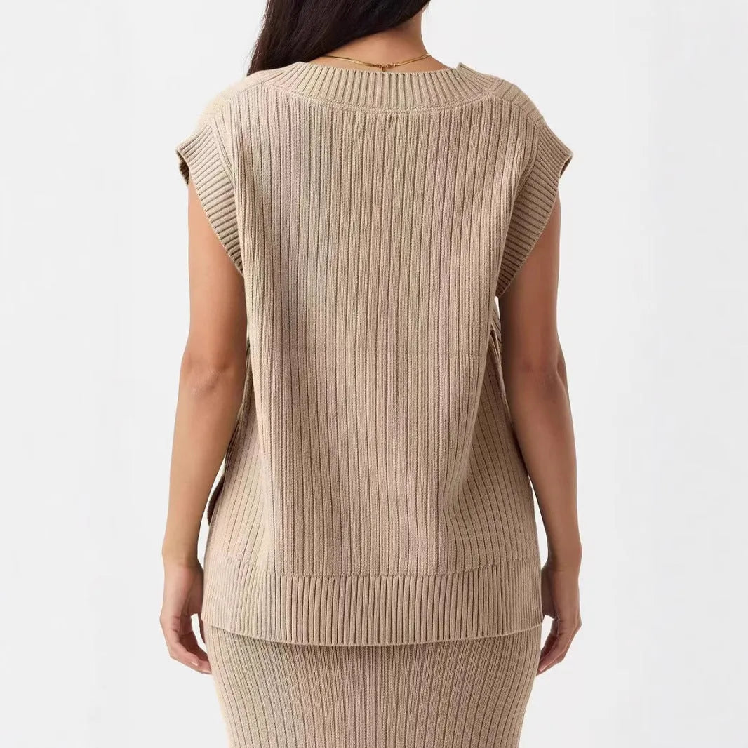 Camel coloured loose v-neck sleeveless vest with a striped pattern on a hanger.