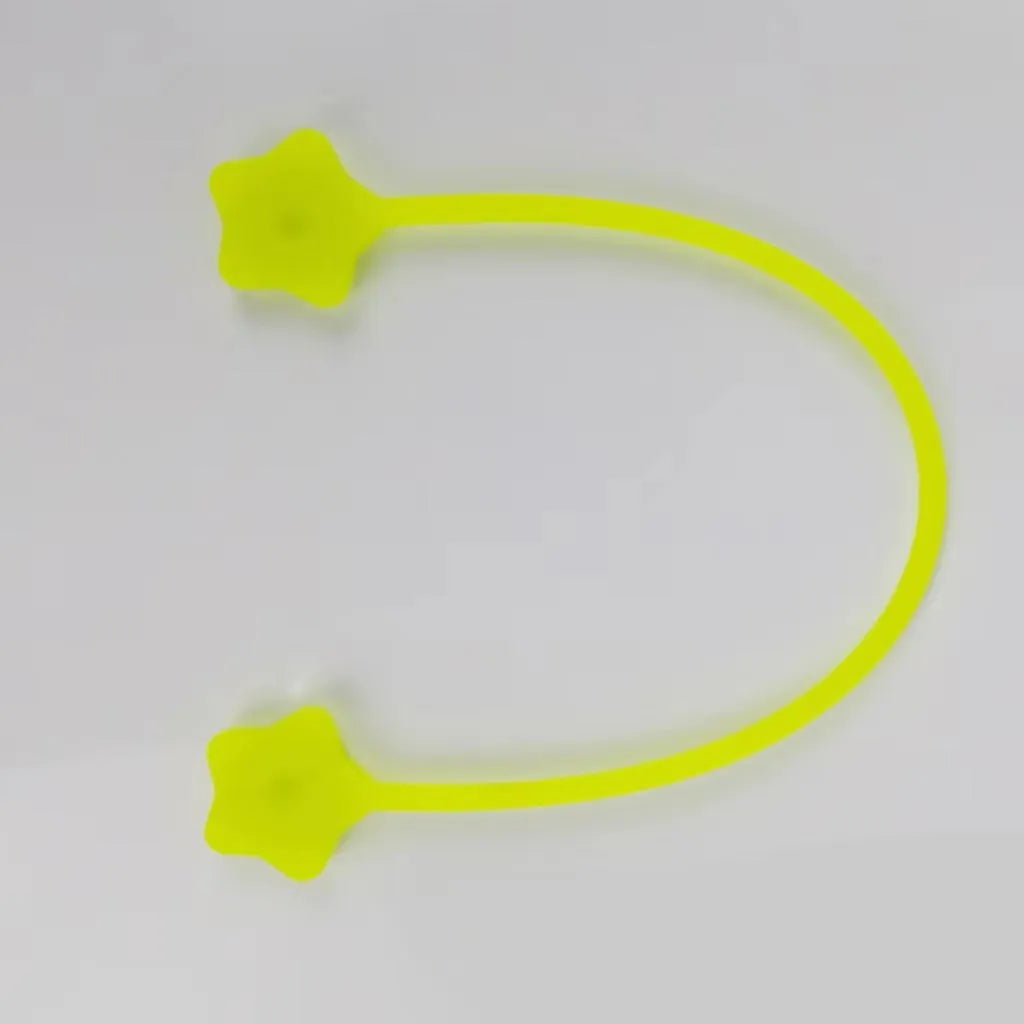 Compact purple silicone cable winder with magnet, shown coiling a white headphone cable.