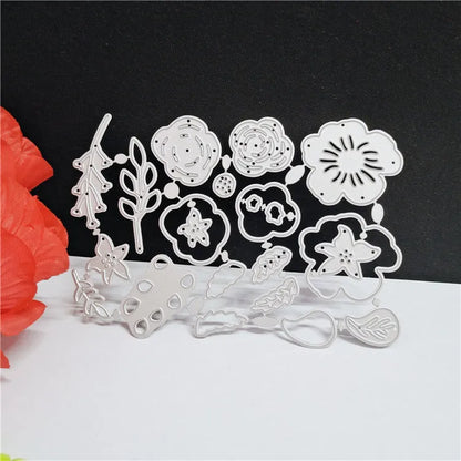 Silver carbon steel flower paper cutting mould measuring 14.3 by 9.9 cm with etched plant design