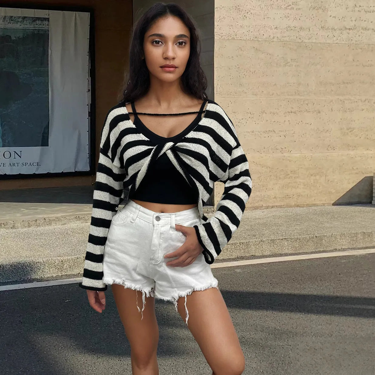 Reversible black and white striped cropped sweater shown worn both front and back.