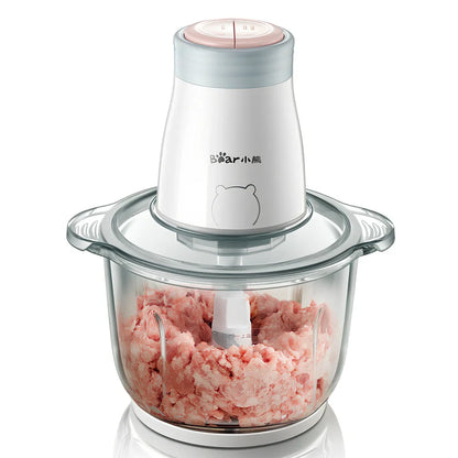 Household electric vegetable chopper blender with glass bowl and stainless steel blade on kitchen counter
